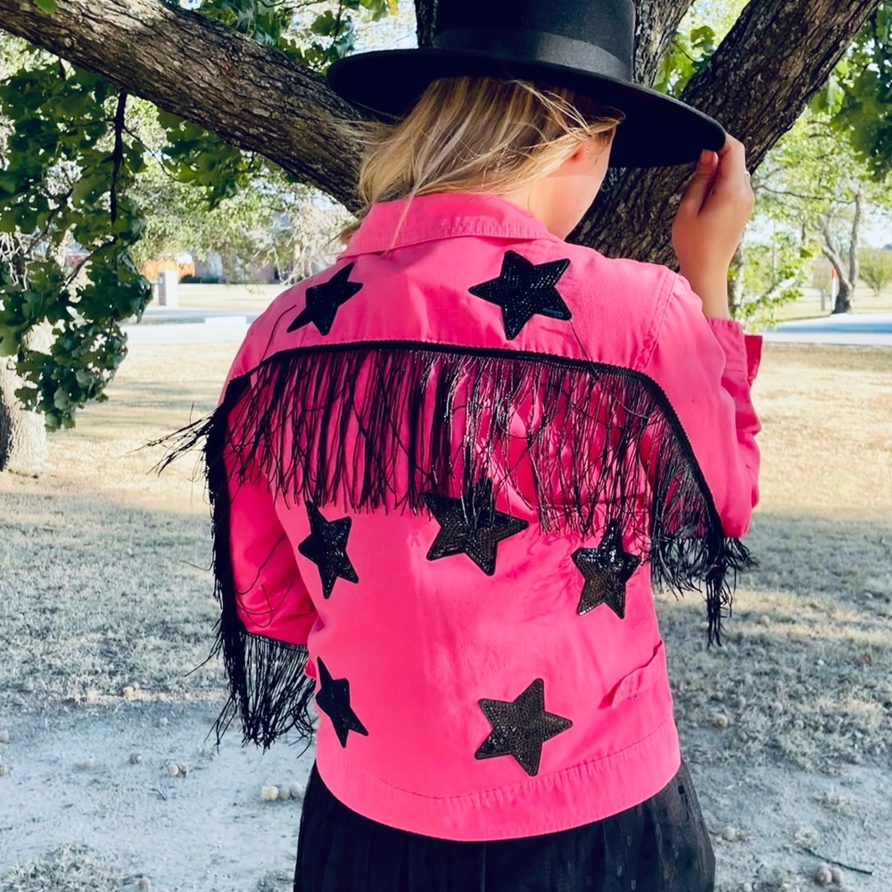 Upcycled pink denim jacket with fringe and star patches